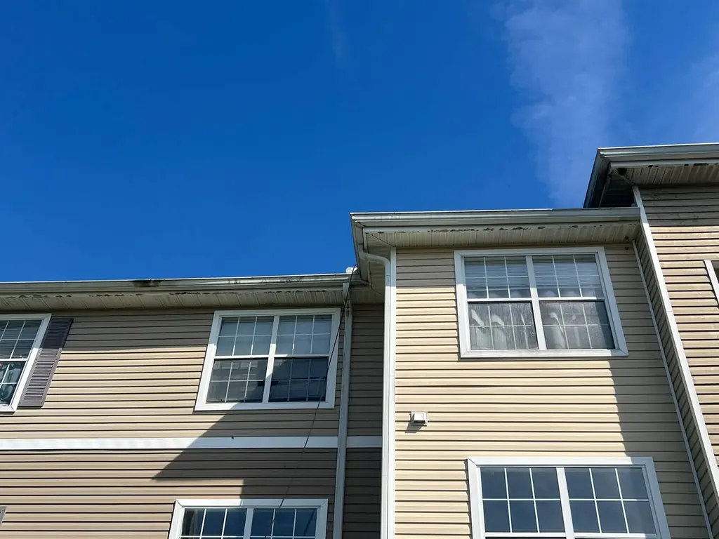 Soft wash on an apartment building exterior